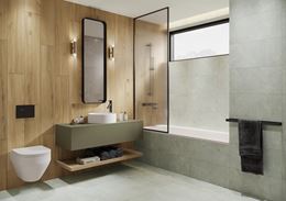 Brązowe drewno i szary kamień w łazience z wanną z parawanem