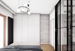 Aranżacja małej sypialni z białą szafa i betonem