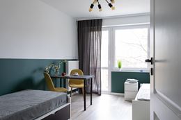 Dwuosobowa sypialnia z lamperią w kolorze zielonym