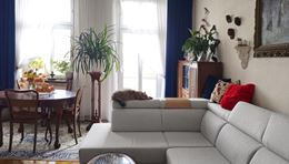 Eklektyczny salon z klasycznym stołem i nowoczesną kanapą