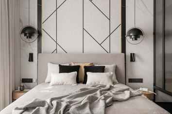 Sypialnia z asymetryczną dekoracją na ścianie i marmurem za łóżkiem
