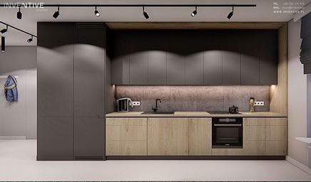 Kuchnia w aranżacji minimalistycznej z wysokimi, szarymi szafkami