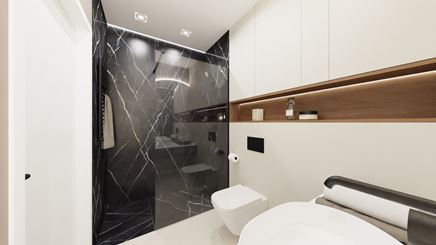 Biała łazienka z czarnym marmurem pod prysznicem