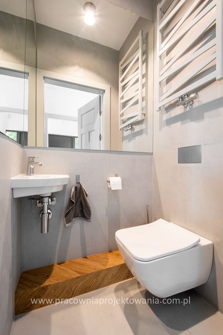 Toaleta w mikrocemencie z drewnianym akcentem