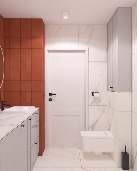 Aranżacja łazienki z pomarańczowymi i białymi kaflami