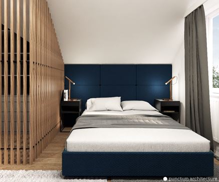 Biała sypialnia z granatowym łóżkiem i tapicerowanym zagłówkiem