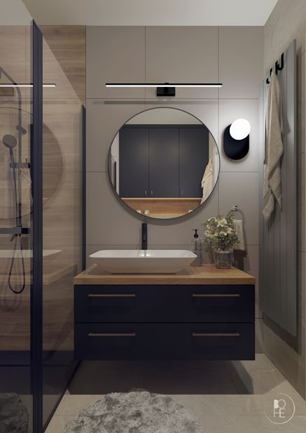 Czarna szafka z drewnianym blatem w szarej łazience