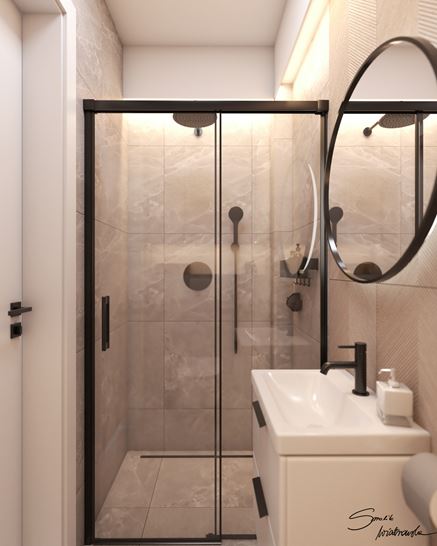 Przesuwne drzwi prysznicowe z czarnym profilem w aranżacji małej łazienki