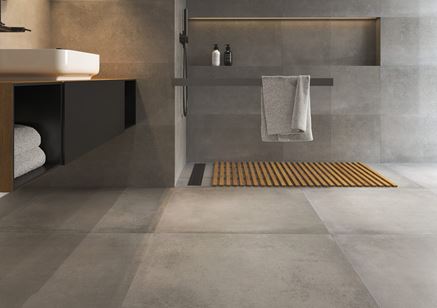 Ściana i podłoga w łazience wykończone betonowymi płytkami