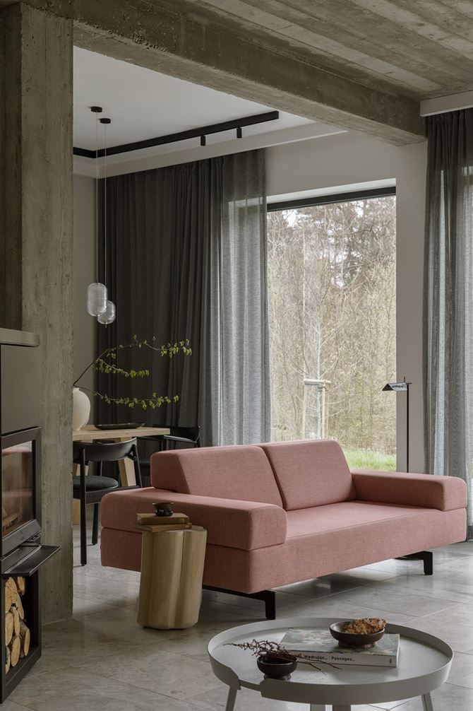 Różowa sofa w salonie, betonowe słupy i sufit. Projekt Minimoo, fot. Y.Hristov.jpg