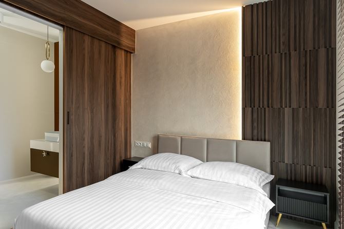 Beżowa sypialnia z drewnianym panelem 3d projektu KODO