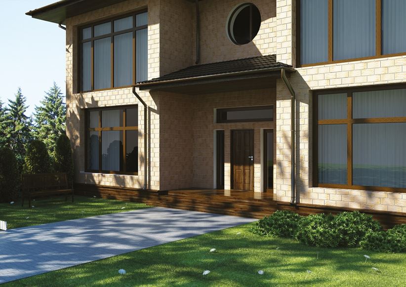 Beżowe cegiełki w wykończeniu elewacji dużego domu