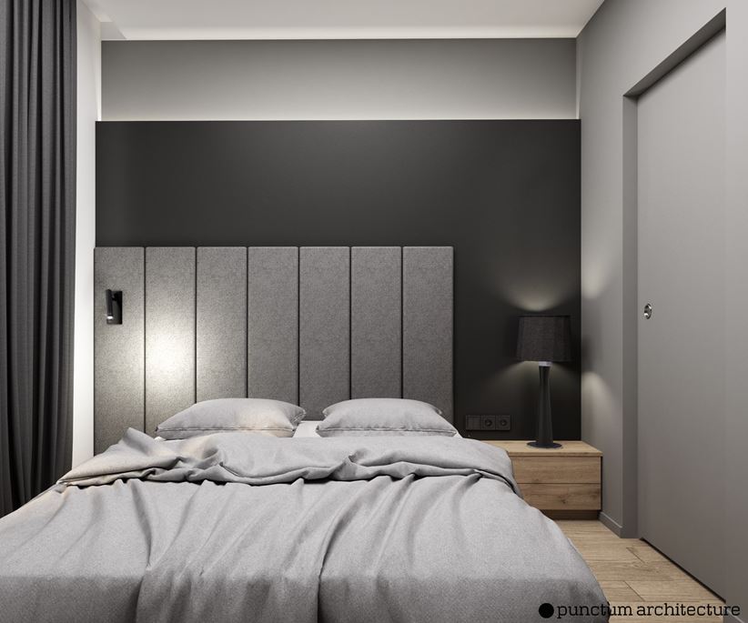 Czarna sypialnia nowoczesna z szarym wezgłowiem łóżka